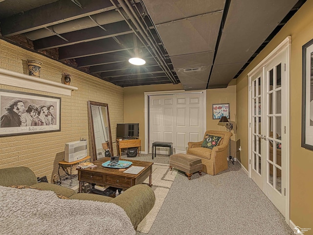 interior space with french doors, brick wall, and carpet flooring