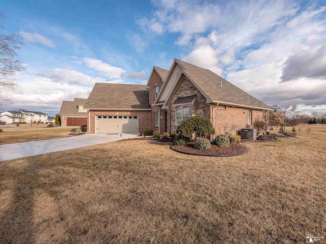 view of front of property with a garage, a front yard, and central air condition unit