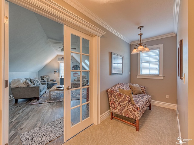 sitting room featuring ceiling fan, lofted ceiling, and ornamental molding