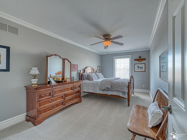 bedroom featuring ornamental molding, light carpet, and a textured ceiling