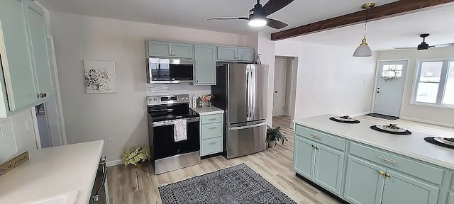 kitchen with ceiling fan, appliances with stainless steel finishes, hanging light fixtures, and light wood-type flooring