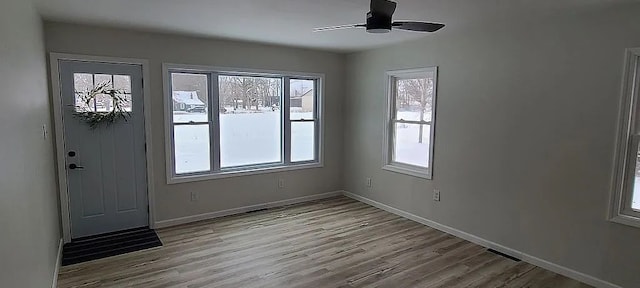 spare room featuring ceiling fan and light wood-type flooring