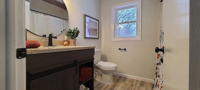 bathroom featuring vanity, hardwood / wood-style floors, and toilet