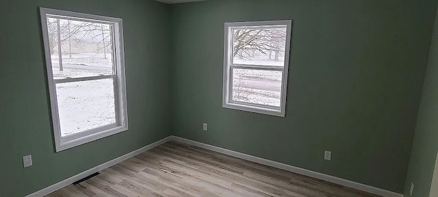 spare room featuring light hardwood / wood-style flooring