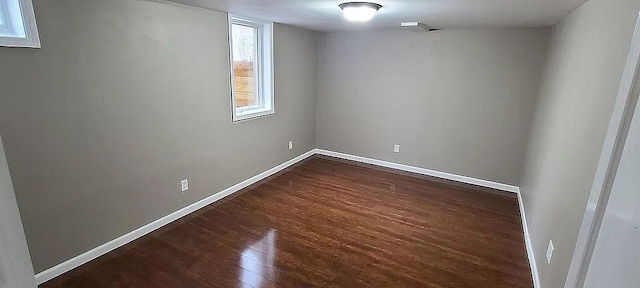 unfurnished room with dark wood-type flooring