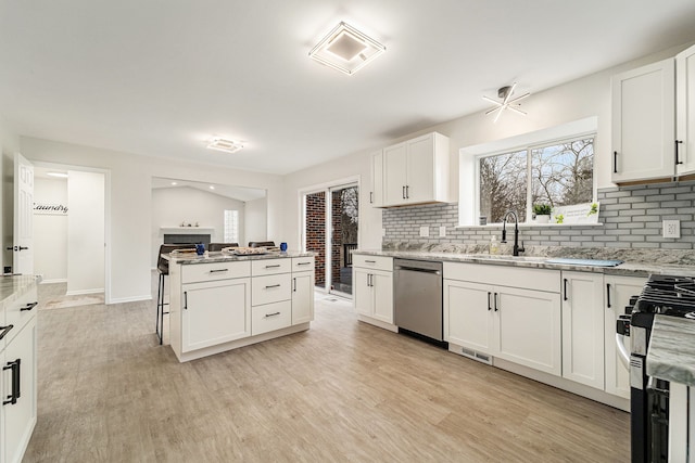 kitchen with white cabinetry, appliances with stainless steel finishes, and light hardwood / wood-style flooring