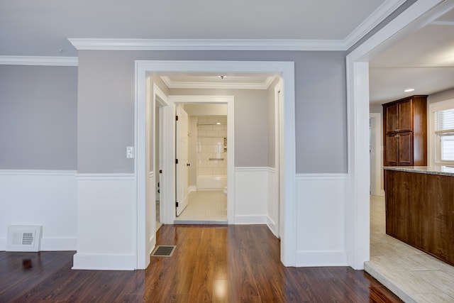 corridor featuring ornamental molding and dark hardwood / wood-style floors