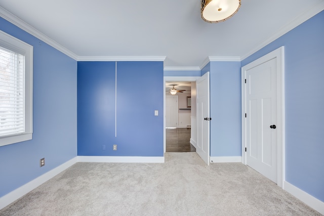 unfurnished bedroom with crown molding and light colored carpet