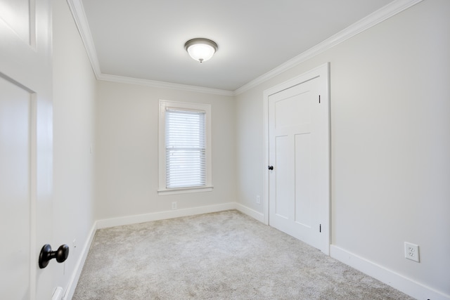 unfurnished room featuring light colored carpet and ornamental molding