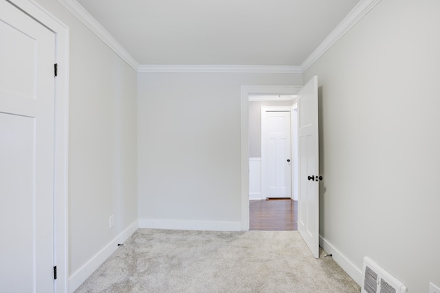 carpeted empty room featuring ornamental molding