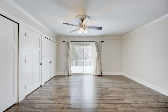 unfurnished bedroom with hardwood / wood-style flooring, ceiling fan, access to exterior, ornamental molding, and two closets