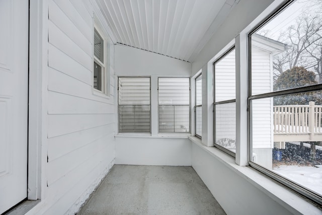 unfurnished sunroom featuring vaulted ceiling