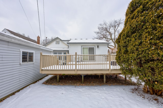 snow covered property featuring a deck