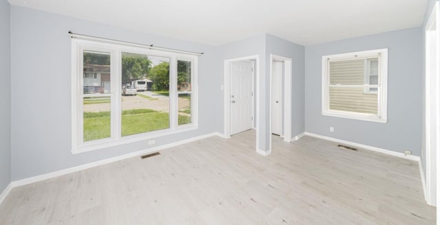 spare room with light wood-type flooring