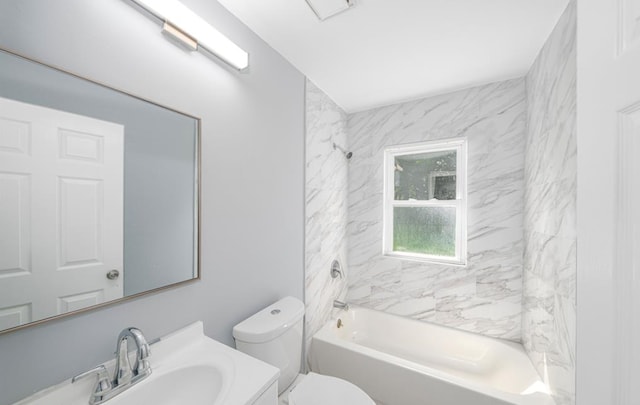 full bathroom with vanity, tiled shower / bath combo, and toilet