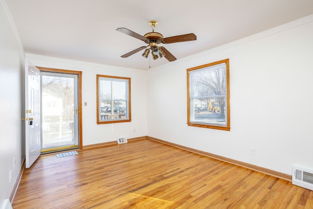 spare room featuring crown molding, ceiling fan, and light wood-type flooring