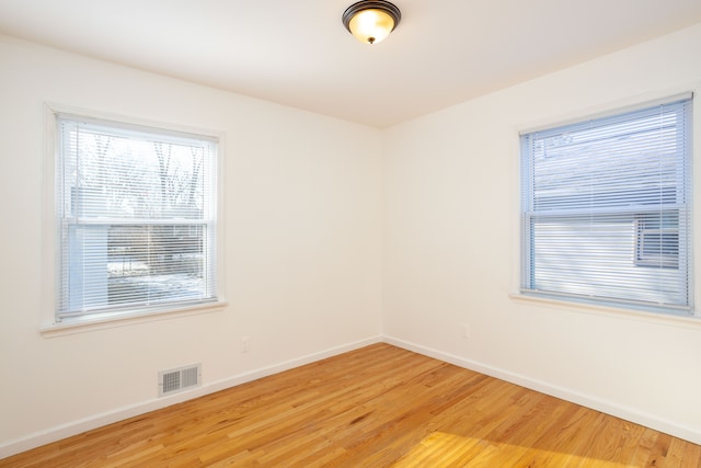 empty room with hardwood / wood-style flooring