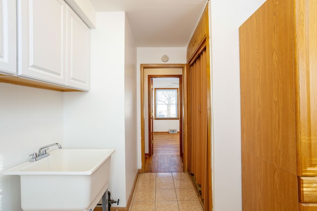 hall with light tile patterned flooring and sink