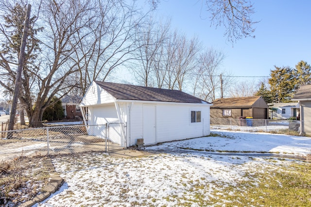 snow covered structure featuring a garage