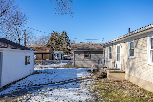 yard covered in snow featuring central AC