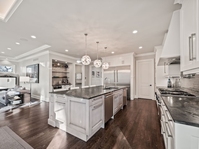 kitchen with stainless steel appliances, open floor plan, a center island with sink, and custom exhaust hood