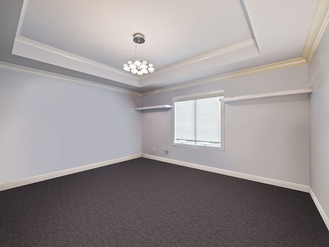 carpeted spare room featuring baseboards, a tray ceiling, and crown molding