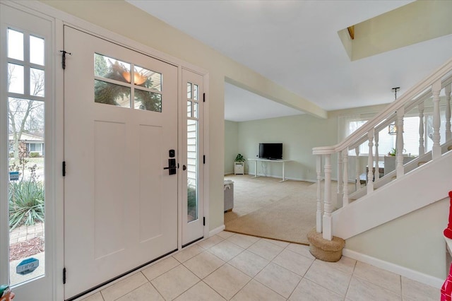 foyer entrance with light carpet