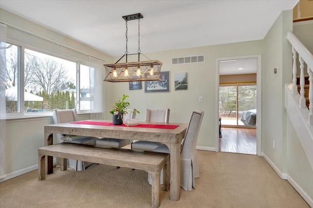 carpeted dining space featuring a wealth of natural light