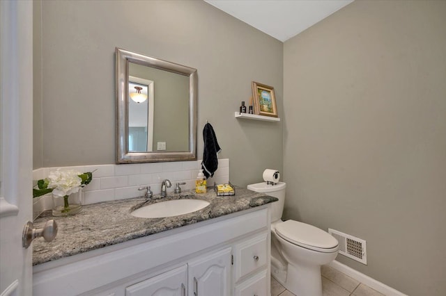 bathroom featuring vanity, backsplash, tile patterned floors, and toilet