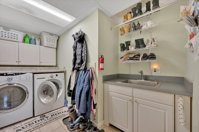 washroom featuring cabinets, independent washer and dryer, sink, and light tile patterned floors