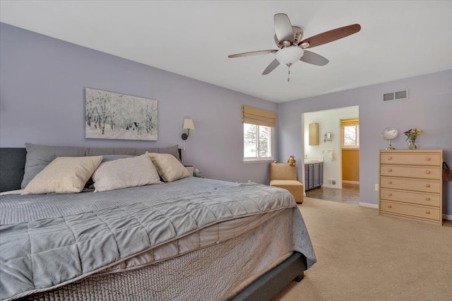 carpeted bedroom with connected bathroom and ceiling fan