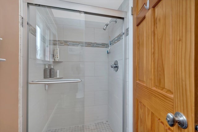 bathroom with a shower with shower door