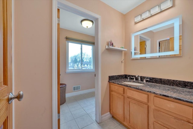 bathroom featuring tile patterned flooring and vanity