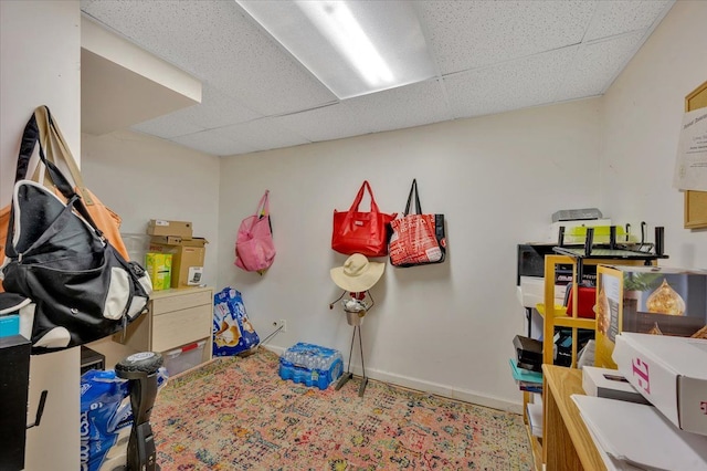 interior space with a paneled ceiling