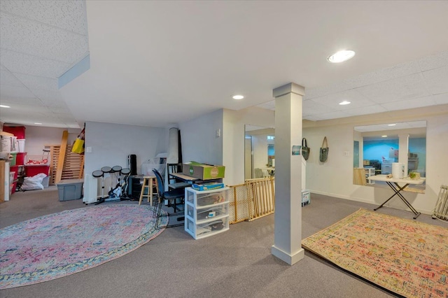 basement featuring carpet and a paneled ceiling