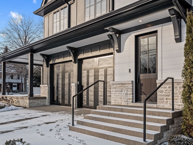 view of snow covered property entrance