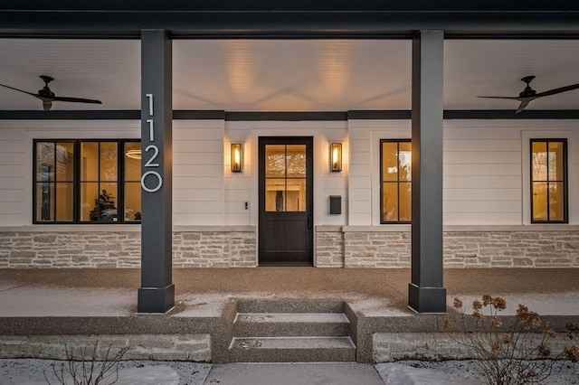 doorway to property featuring ceiling fan