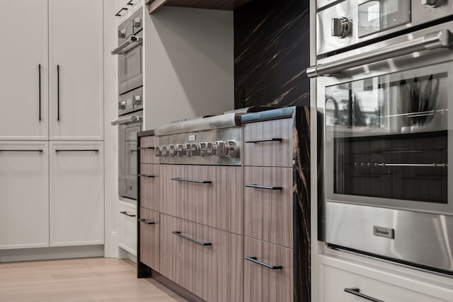 kitchen with white cabinetry and light wood-type flooring