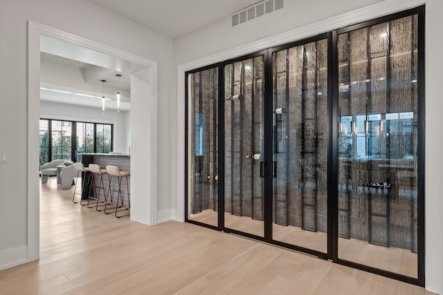 doorway to outside featuring wood-type flooring