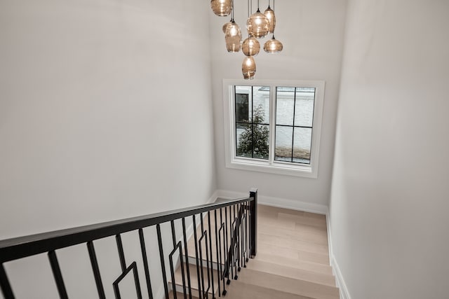 stairway with hardwood / wood-style flooring