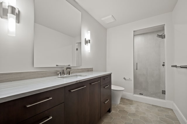 bathroom featuring vanity, walk in shower, and toilet