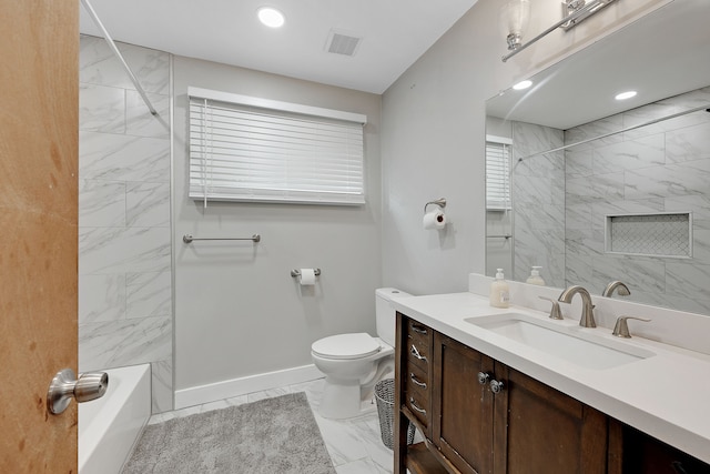 full bathroom featuring tiled shower / bath combo, vanity, and toilet