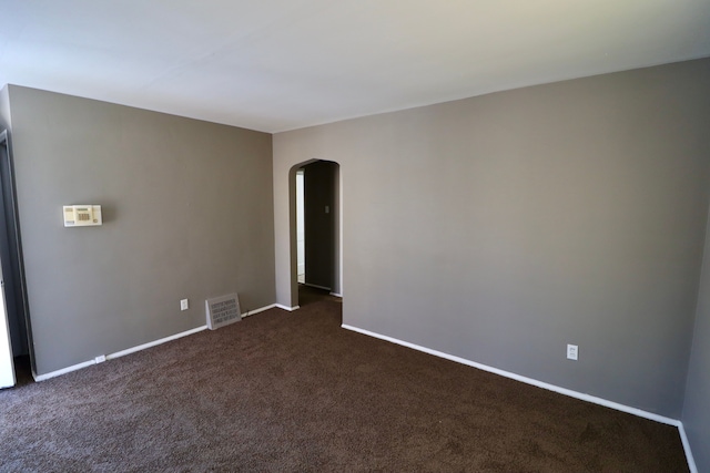 empty room featuring dark colored carpet