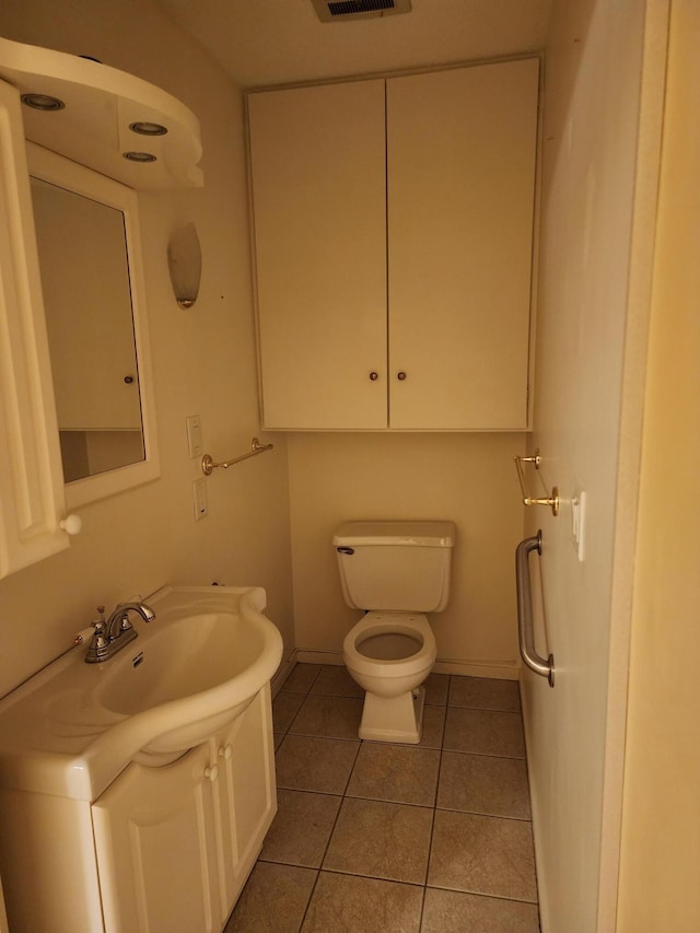 bathroom featuring tile patterned flooring, vanity, and toilet