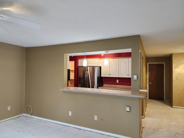 kitchen featuring stainless steel fridge with ice dispenser, decorative light fixtures, kitchen peninsula, and white cabinets