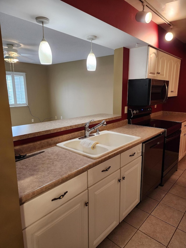 kitchen featuring white cabinetry, black dishwasher, sink, and decorative light fixtures