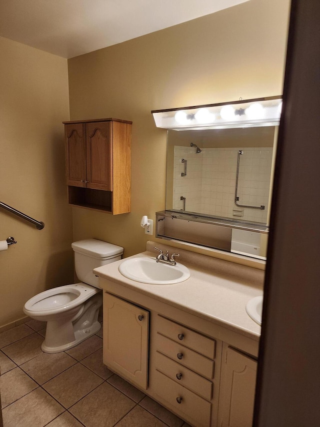 bathroom with vanity, tile patterned floors, and toilet