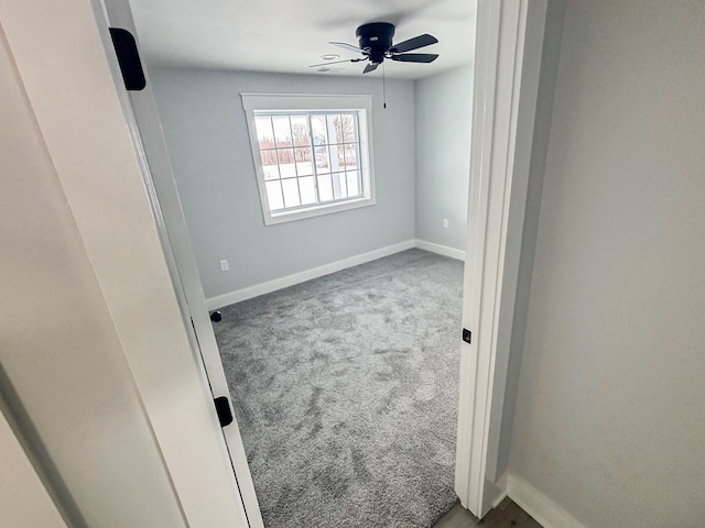 empty room featuring ceiling fan and carpet flooring