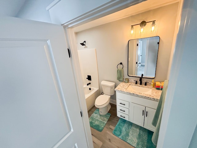 full bathroom featuring hardwood / wood-style flooring, vanity, toilet, and bathing tub / shower combination