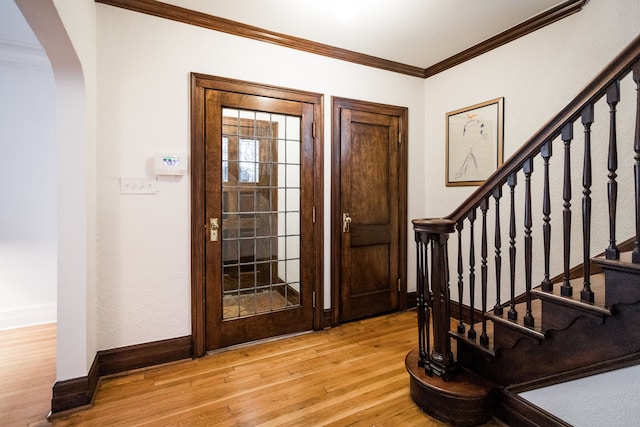 foyer entrance featuring ornamental molding and light wood-type flooring